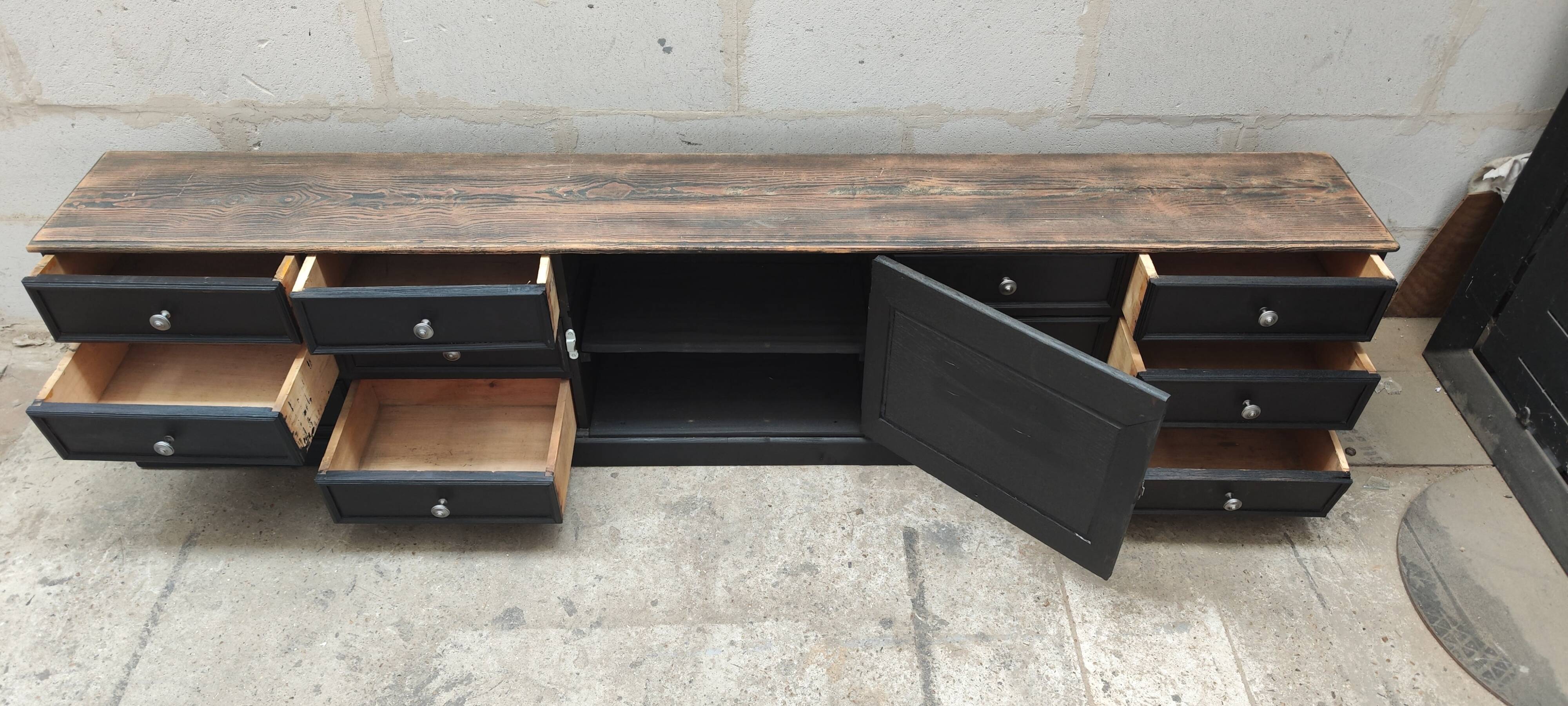 Low TV cabinet with black patina, twelve drawers and one door