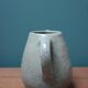 Small ceramic pitcher enamelled pale green, signed Max Idlas