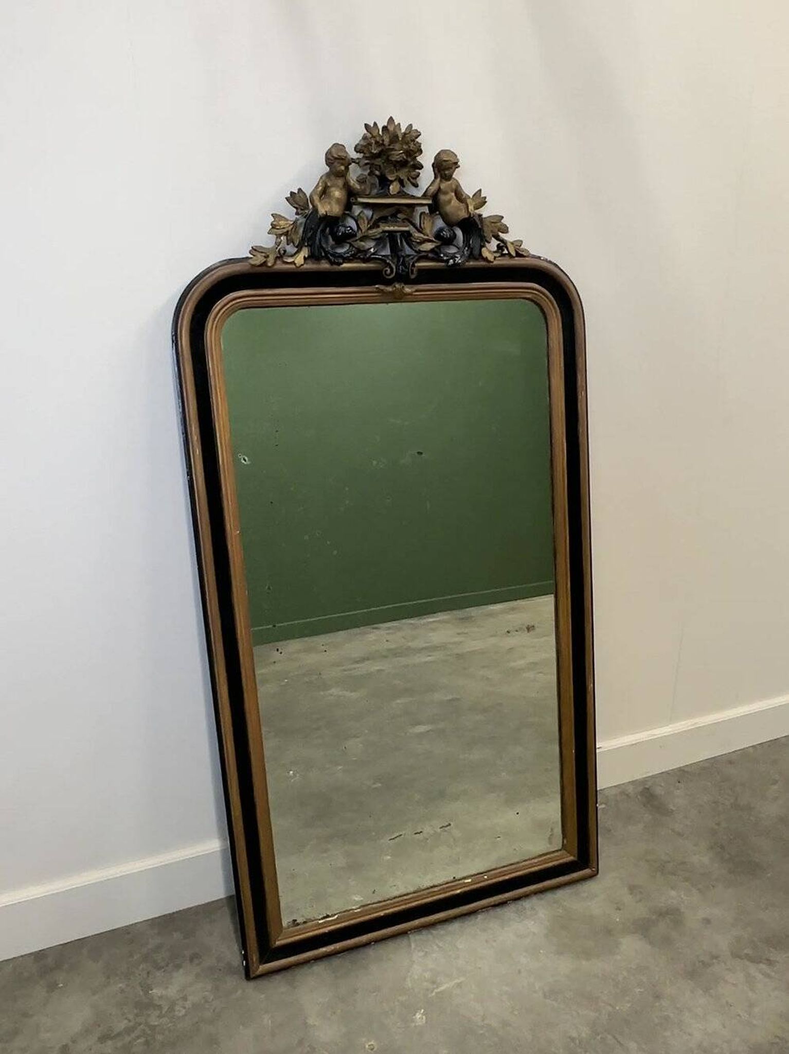 Antique 1800s black and gold mirror with cupid, France 1800s.
