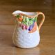 Hand-painted earthenware carafe with a raised vegetable basket design