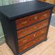 Vintage commode revamped in matte black & wood with warm tones.