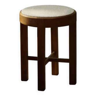 Mid-century Danish stool in oak, reupholstered in boucle wool, circa 1950.