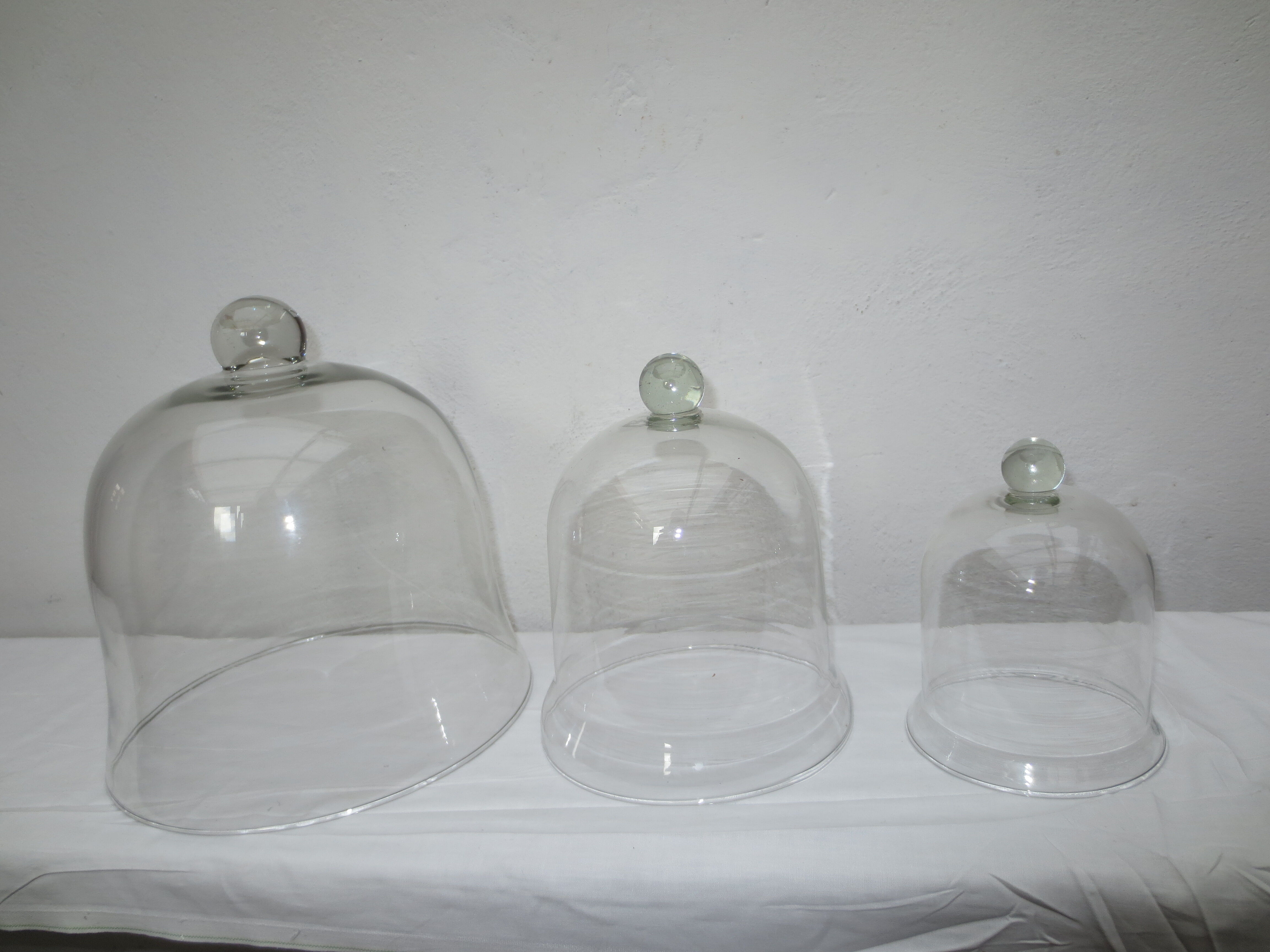 trio of old bells in transparent glass