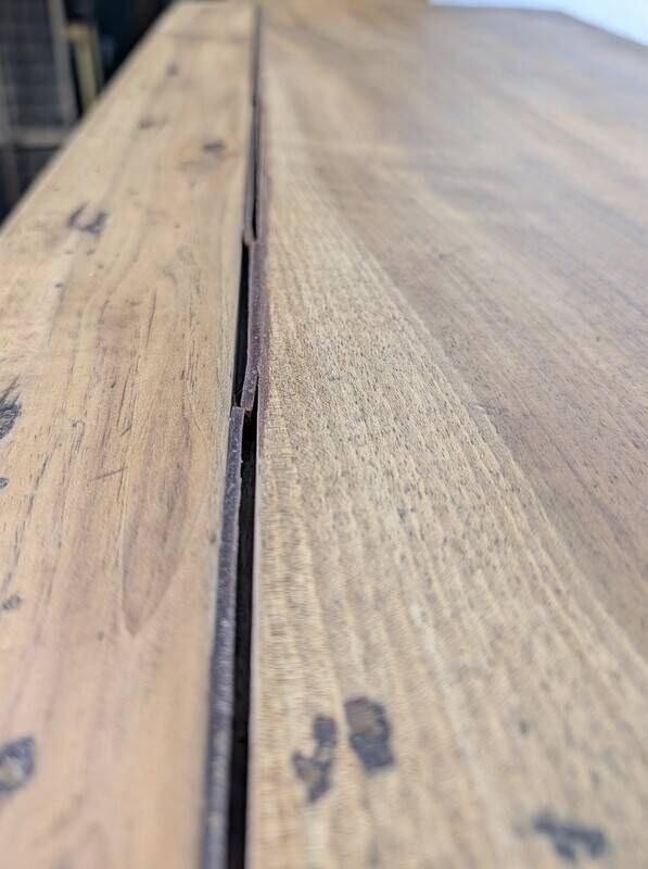 Antique wooden drop-leaf table with turned legs.