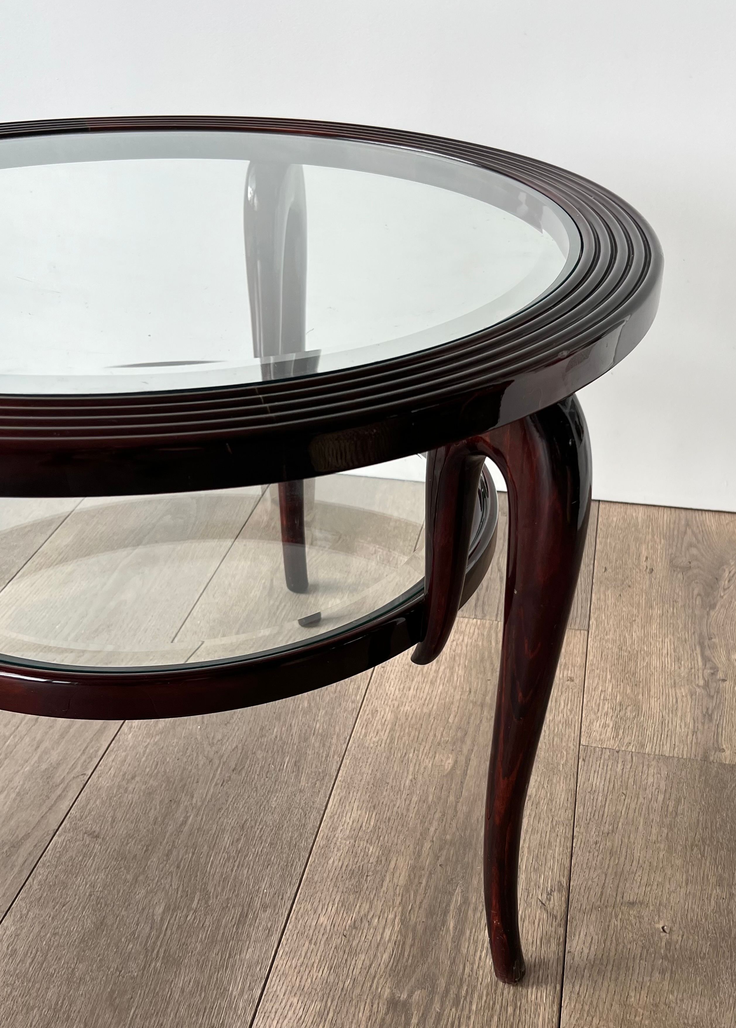 Round mid-century coffee table in walnut with a double top by Paolo Buffa.