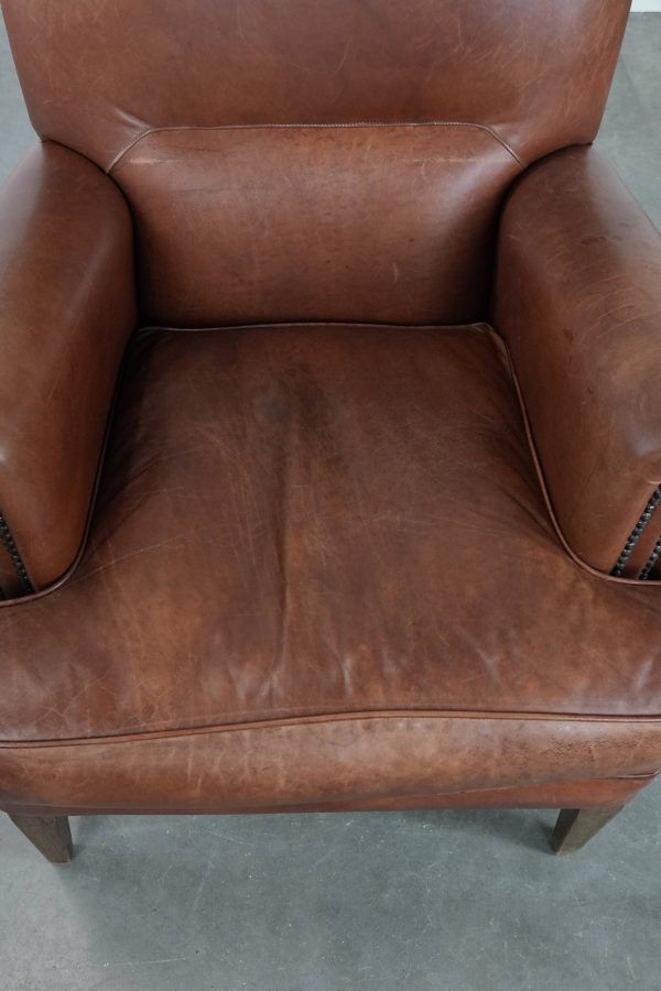 Fauteuil confortable en cuir de vache couleur cognac de style anglais
