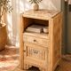 Small Art Deco bedside table in light wood with a terrazzo effect top.