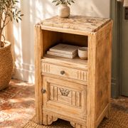 Small Art Deco bedside table in light wood with a terrazzo effect top.
