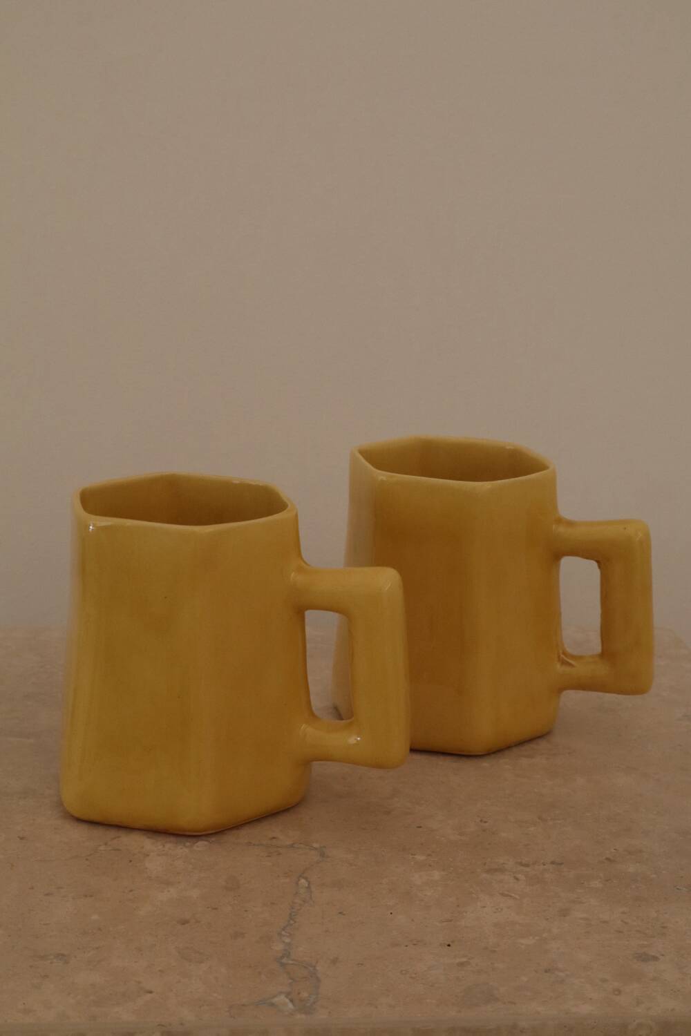 Set of two designer lemon yellow ceramic mugs