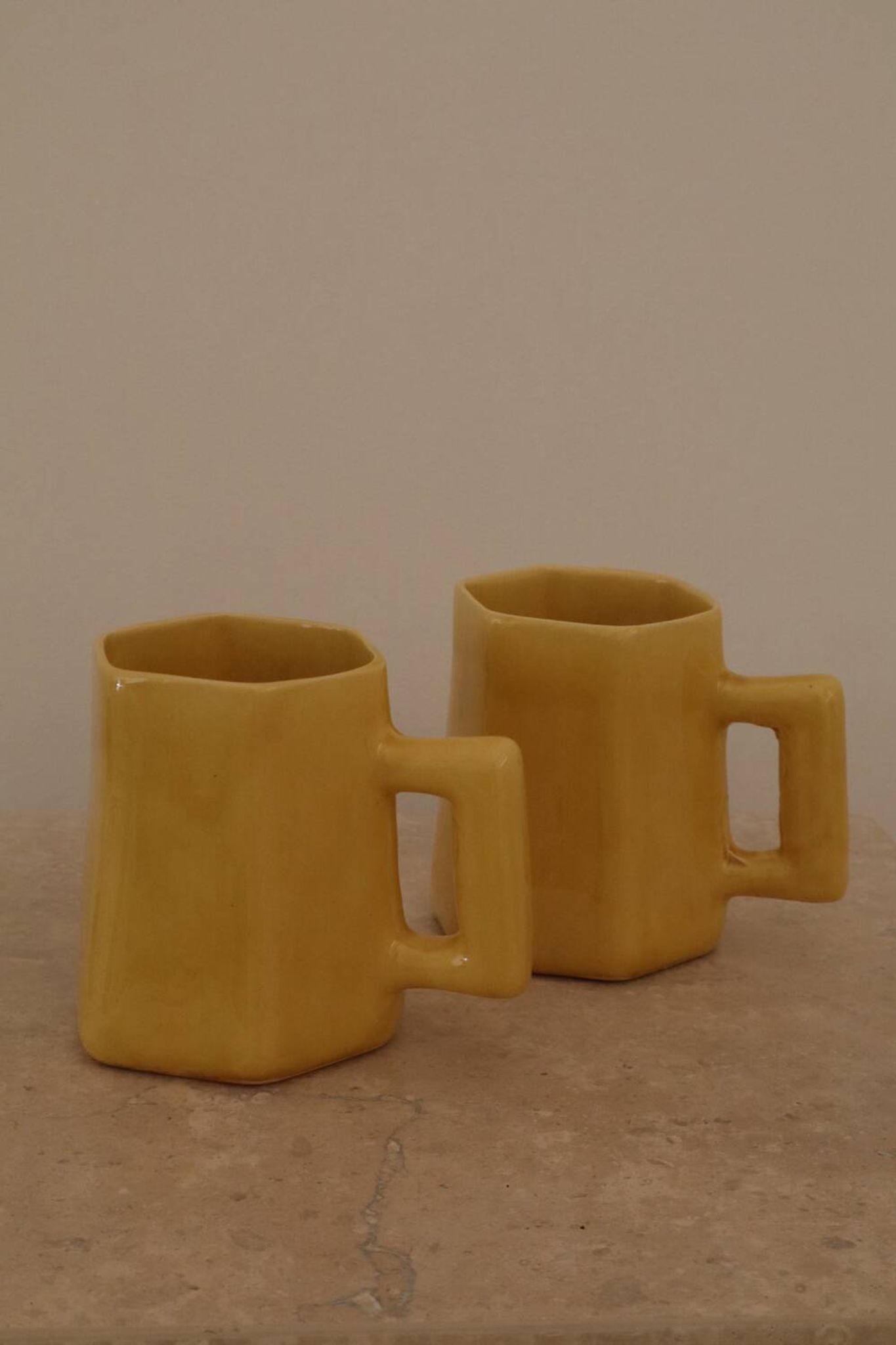 Set of two designer lemon yellow ceramic mugs
