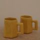 Set of two designer lemon yellow ceramic mugs