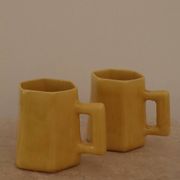 Set of two designer lemon yellow ceramic mugs