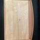 Blonde wooden doll's chest with brass handles.