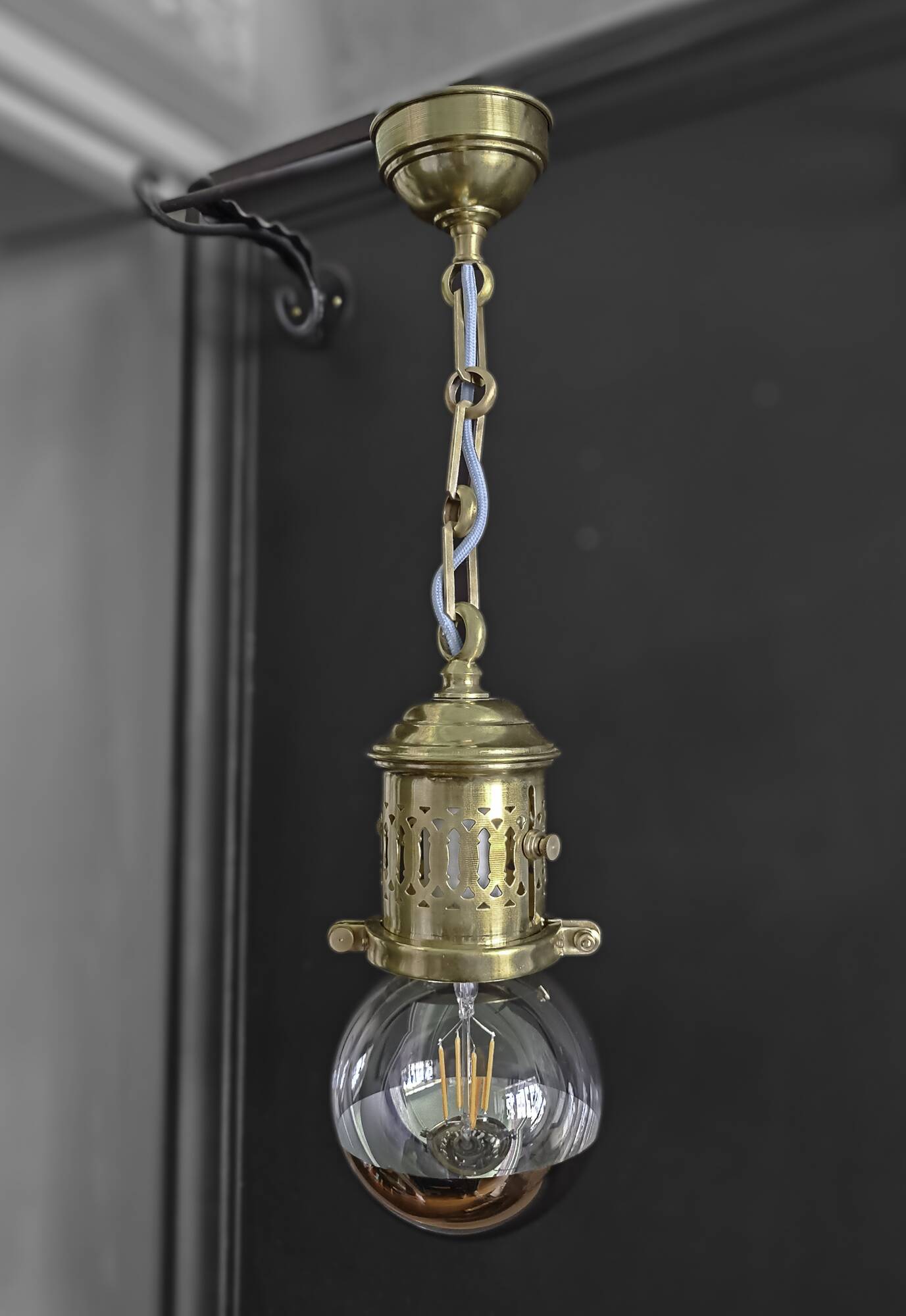 Brass pendant light with oversized LED bulb