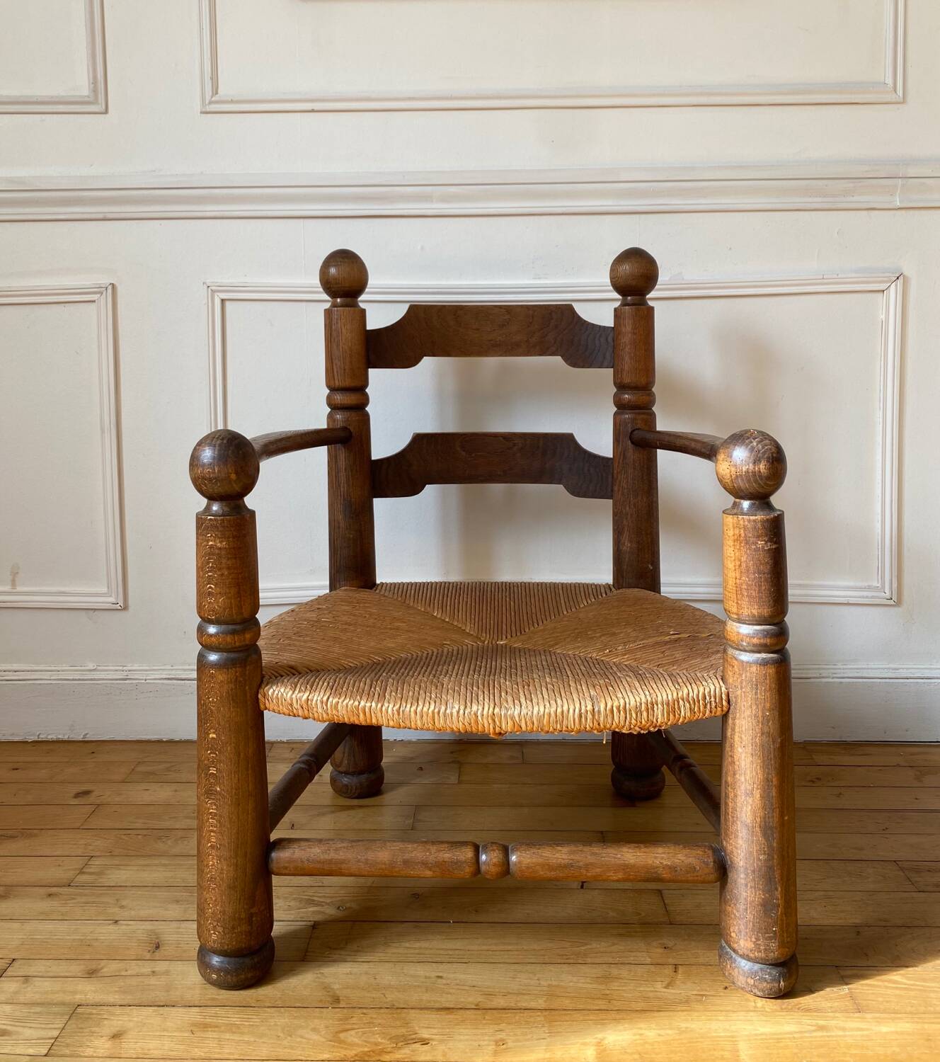 Straw and turned wood fireplace armchair in the style of Charles Dudouyt