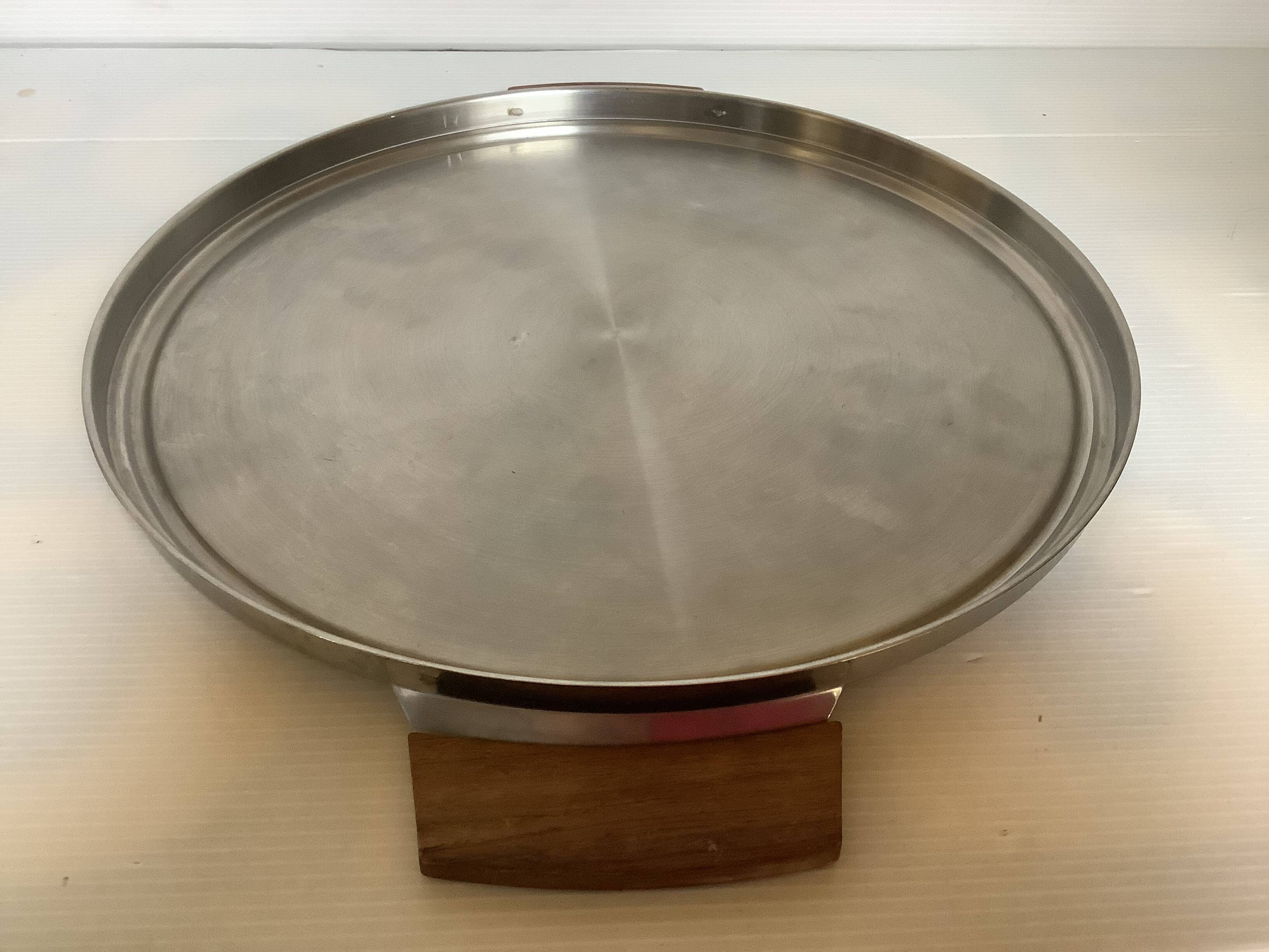 Large flat metal and wood platter in Scandinavian style.