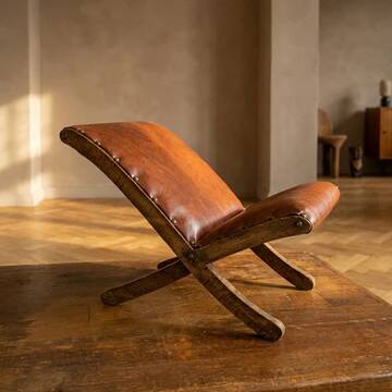 Old retro footstool, mid-century wooden leather stool, mid 20th century, European