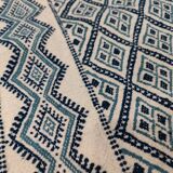 White and blue hand-woven rug in natural wool