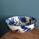 Empty pocket bowl in terracotta, glazed with "ink spots" design.