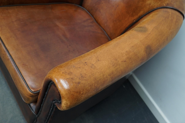 Paire de fauteuils club vintage en cuir cognac