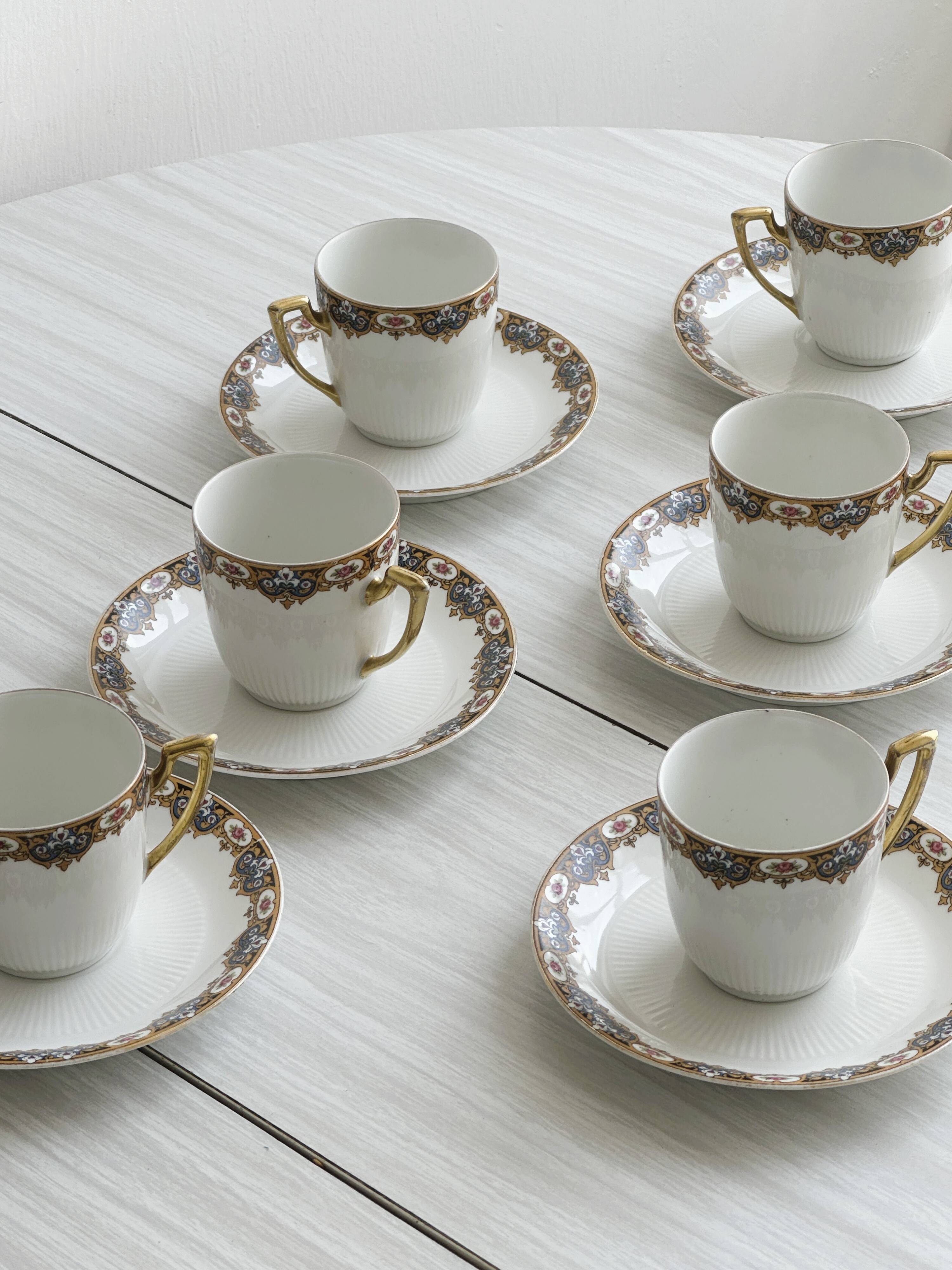 7 Limoges porcelain cups and saucers with gold decoration and floral motif.