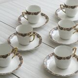 7 Limoges porcelain cups and saucers with gold decoration and floral motif.