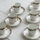 7 Limoges porcelain cups and saucers with gold decoration and floral motif.