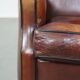 Vintage sheepskin leather armchair finished with black piping