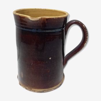 Old pitcher in brown terracotta