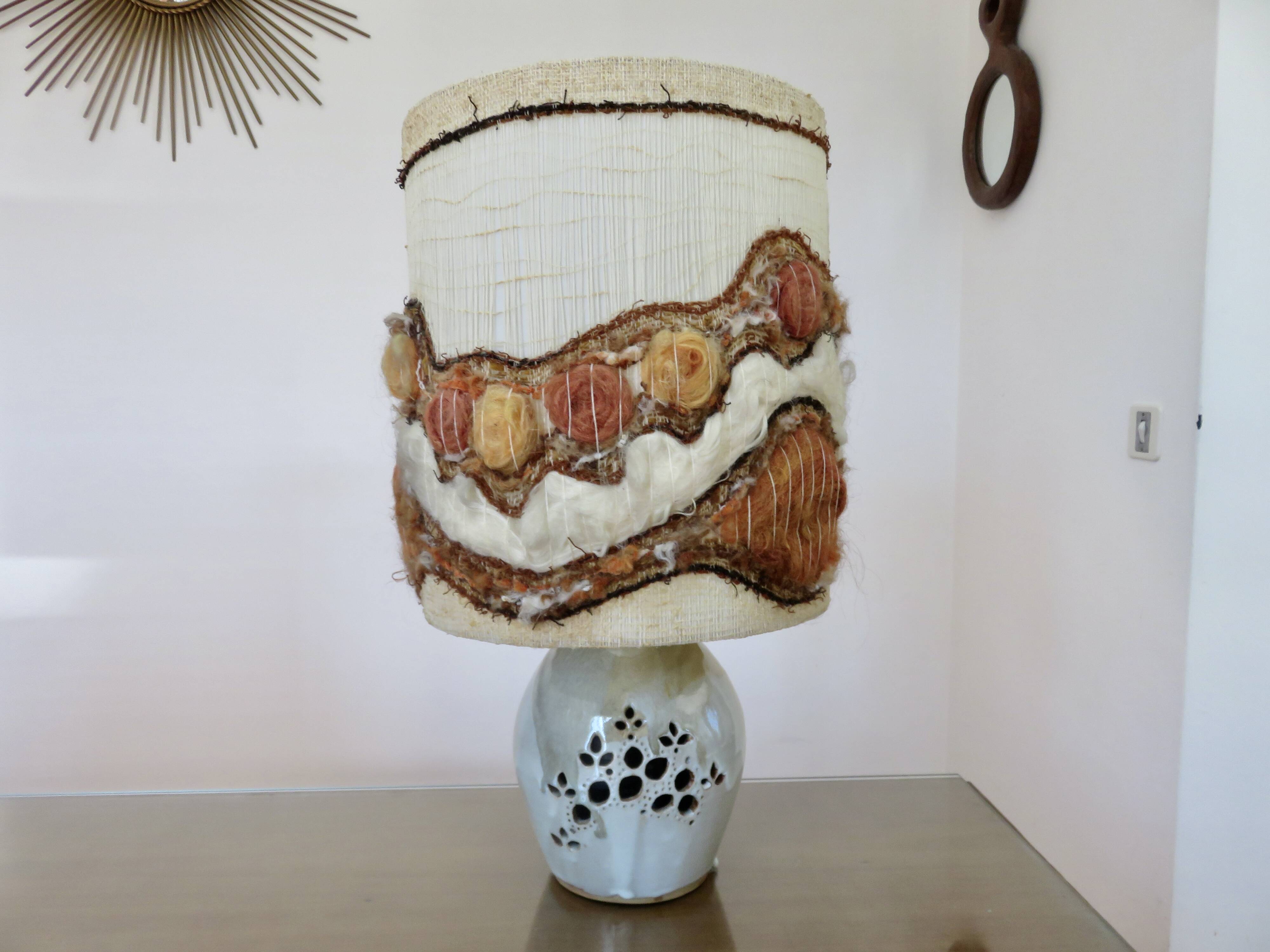 Ceramic lamp with double lighting and openwork design.