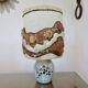 Ceramic lamp with double lighting and openwork design.