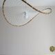 Curved rattan and rope pendant light