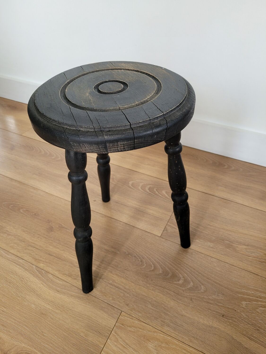 Black wooden tripod stool