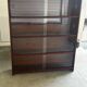 Vintage 1960s wooden library with sliding doors.