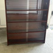 Vintage 1960s wooden library with sliding doors.