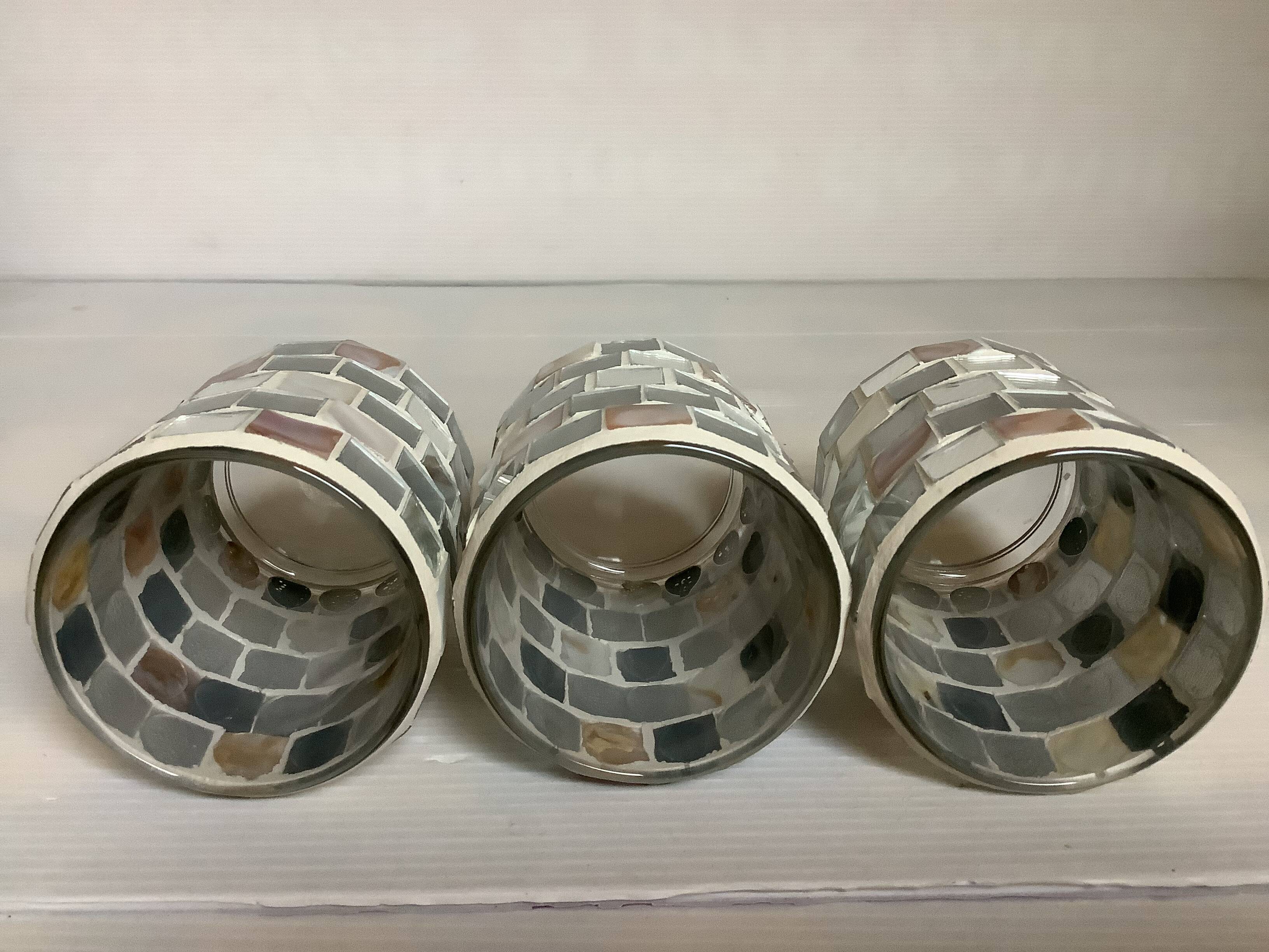 Four mosaic mirror and mother-of-pearl candle holders.