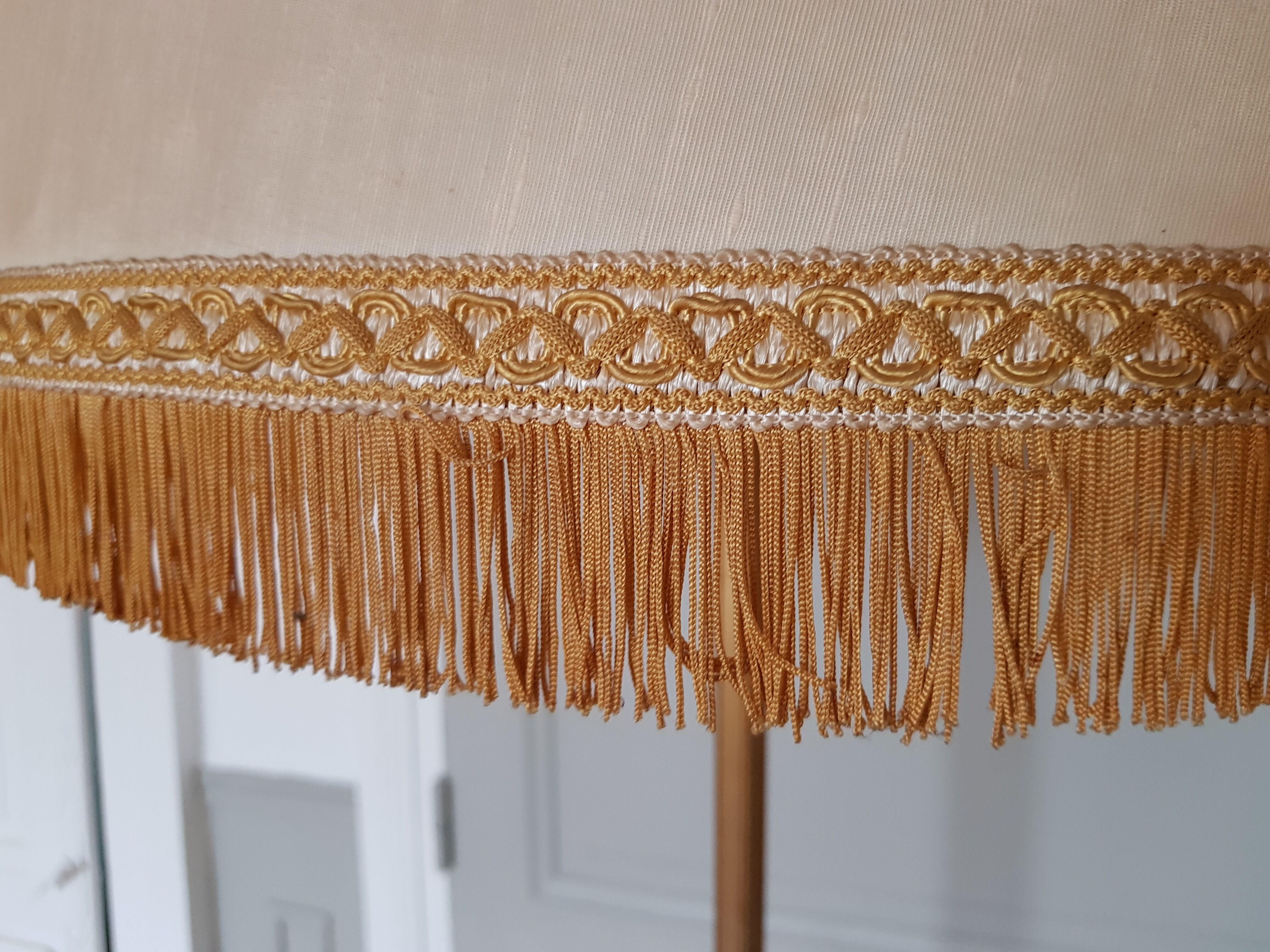 Authentic antique lamppost in gilded brass lampshade in fringed cream fabric