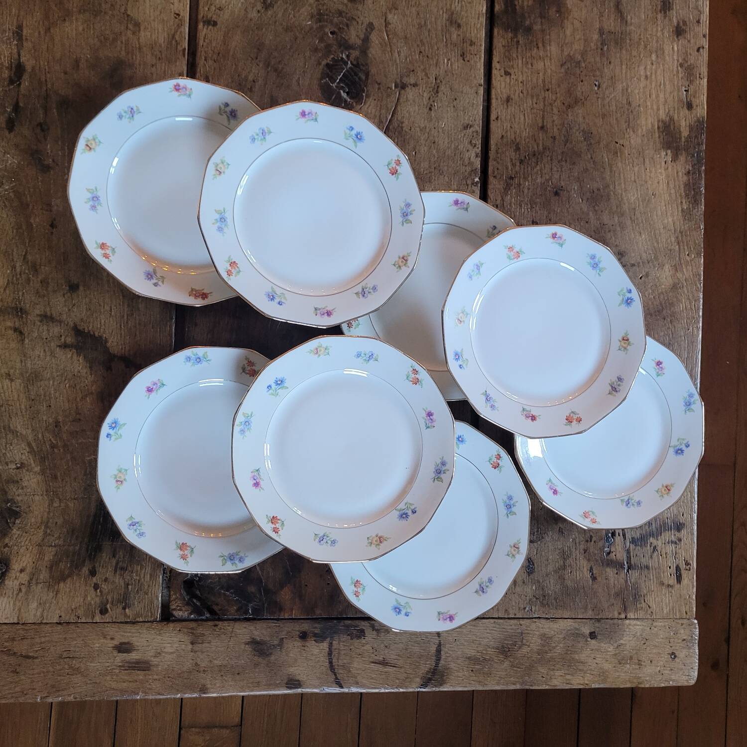 8 porcelain dessert plates with gold rim and various flowers