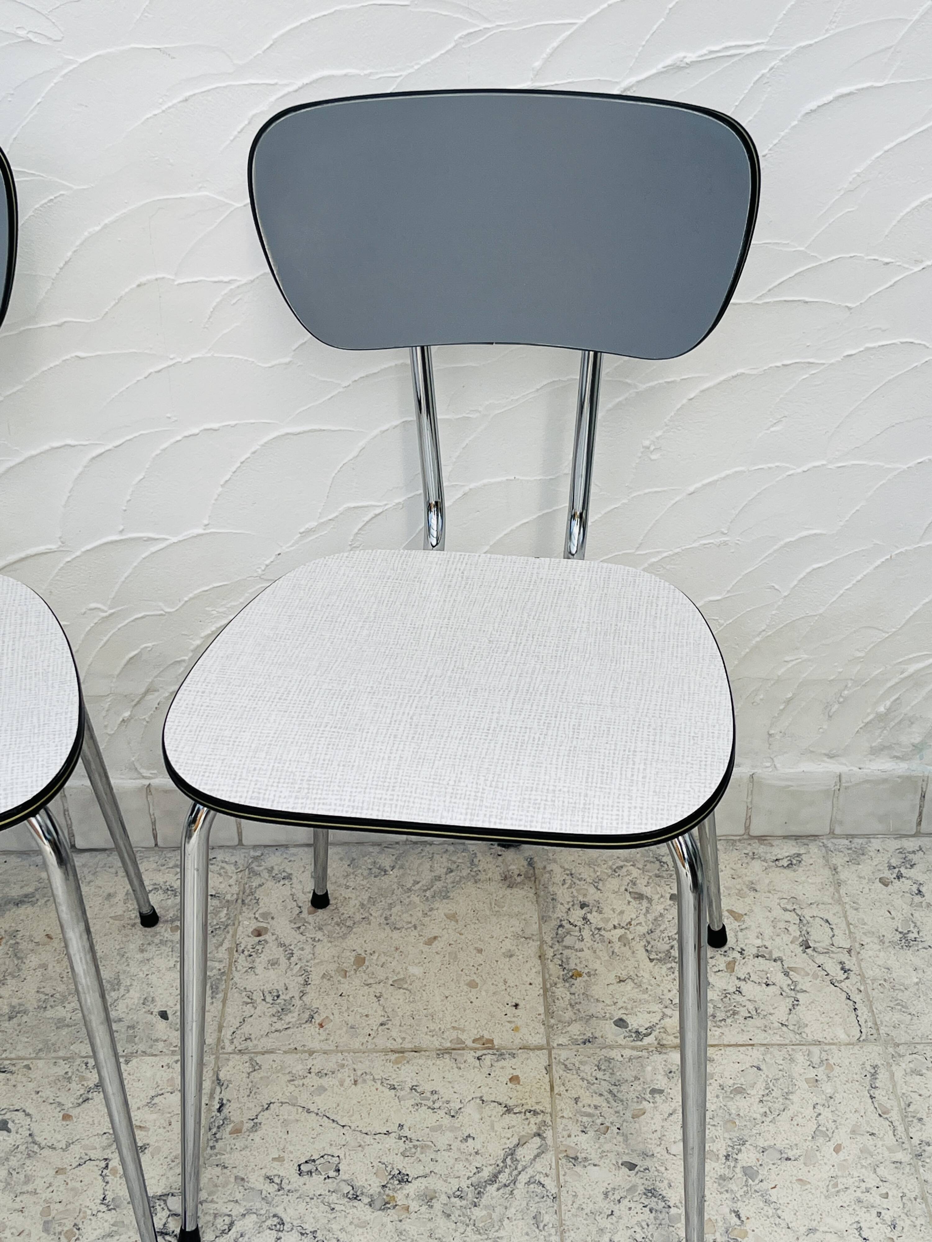 Set of two vintage grey Formica and chrome chairs.
