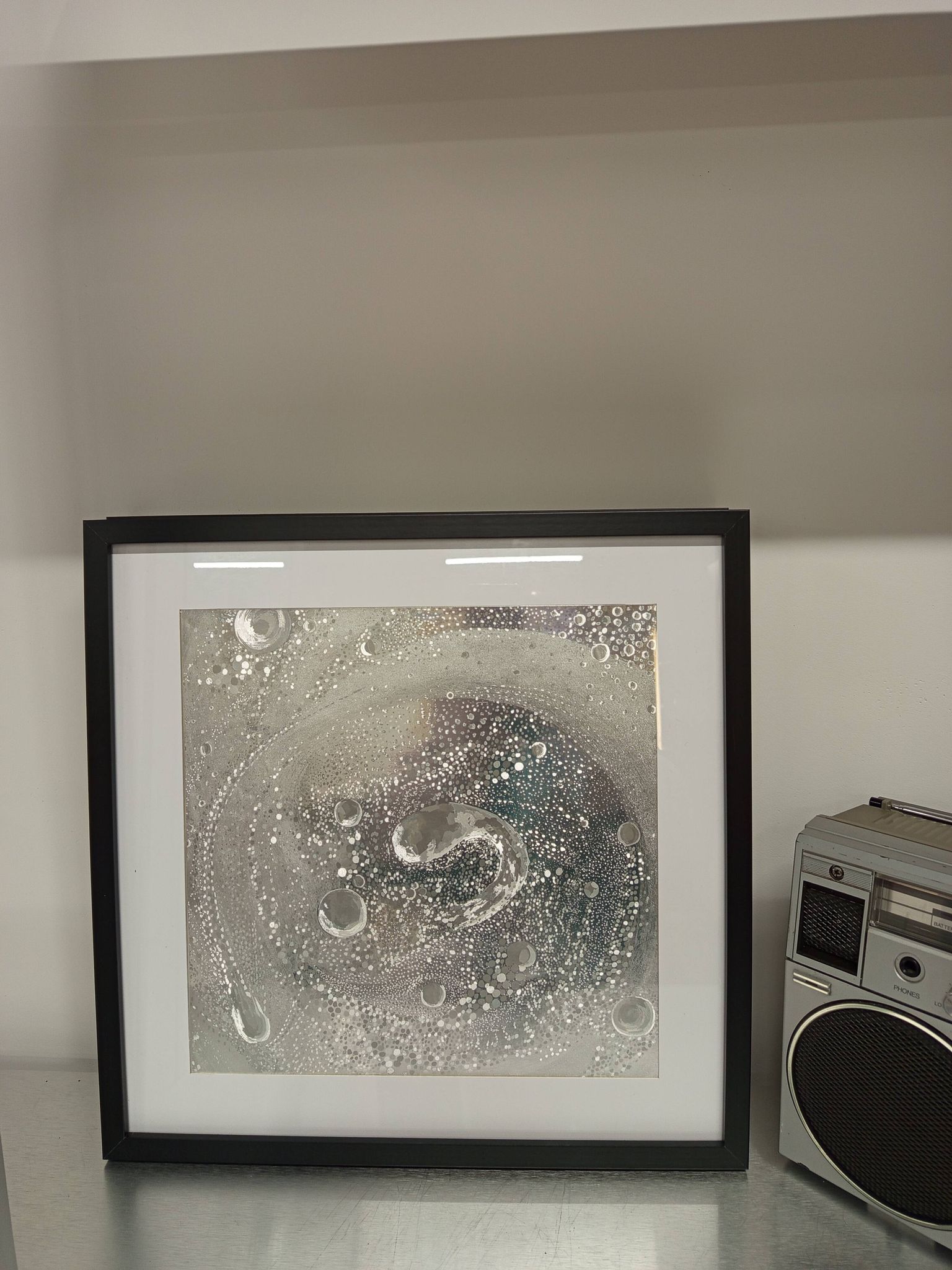 a Kinetic Op Art Aluchromy under glass frame.