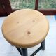Low wooden stool and black patina