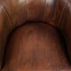Sheepskin clubarmchair with beautiful patina finished with decorative nails