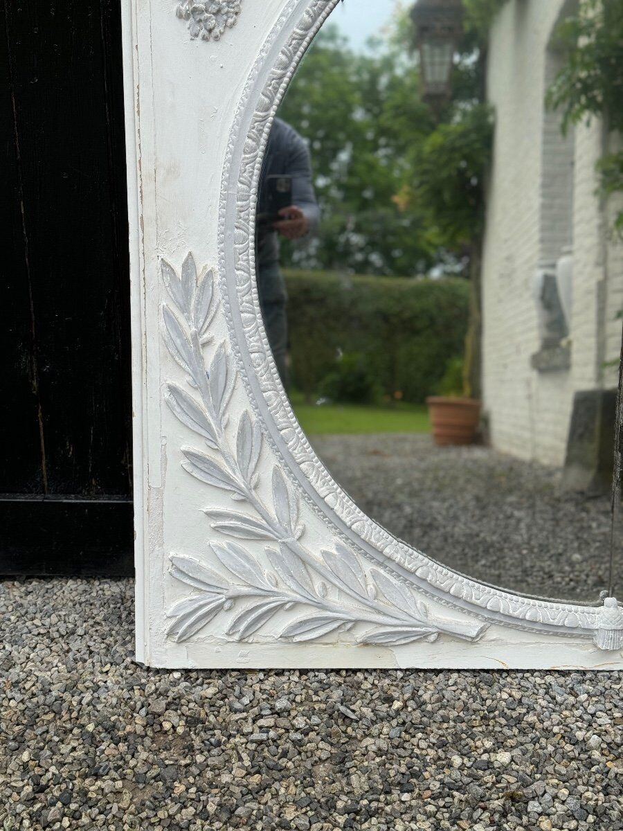 Louis XVI style fireplace mirror, carved wood trumeau with white and grey highlights, 18th century
