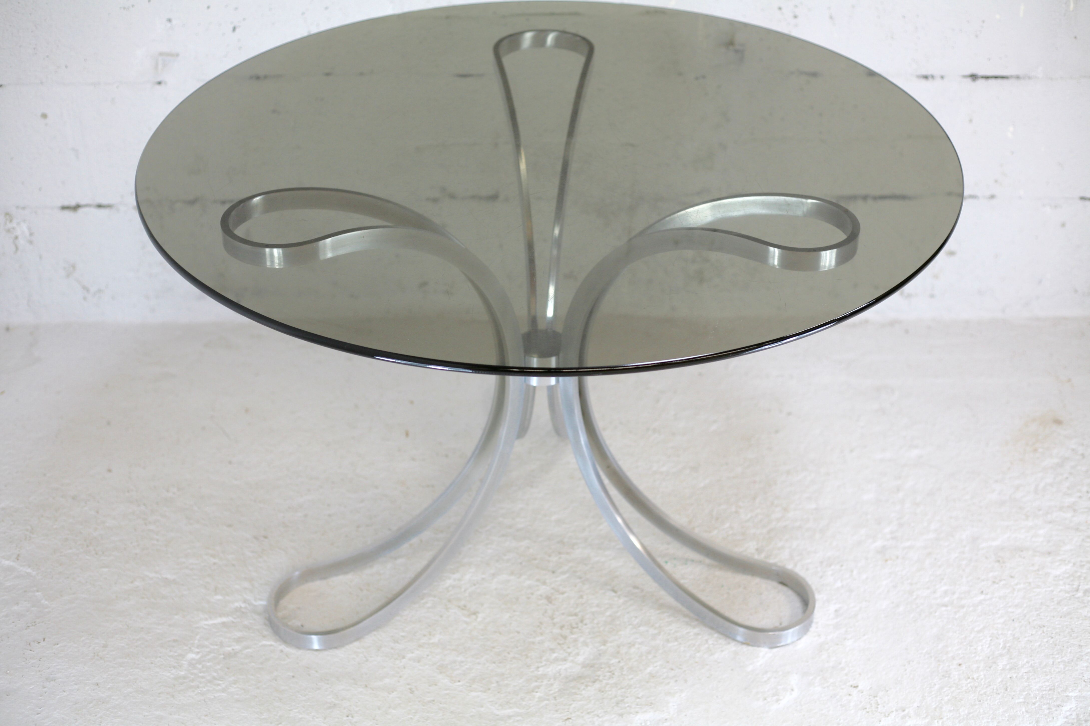 Living room table "Space Age" polished steel, circular slab smoked glass. France, circa 1970.