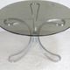 Table de séjour "Space Age" acier poli, dalle circulaire verre fumé. France, circa 1970.