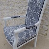 Voltaire style armchair covered in floral fabric in quality aged wood