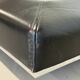 Vintage coffee table covered in leather, smoked mirror top and chrome legs.
