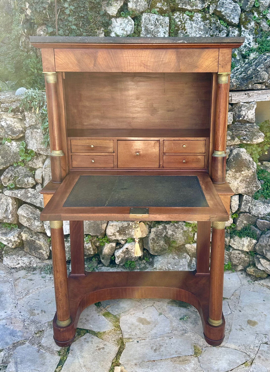 A small piece of Bonheur du jour with detached columns in Empire-era mahogany.