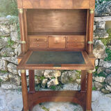 A small piece of Bonheur du jour with detached columns in Empire-era mahogany.