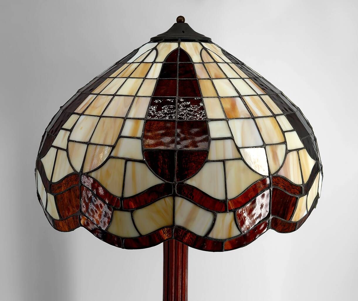 Art Deco floor lamp in carved walnut, stained glass shade, France, c. 1920
